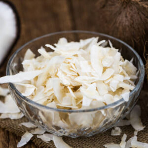 Coconut chips (fresh) as detailed close up shot, selective focus)