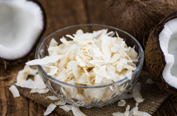 Coconut chips (fresh) as detailed close up shot, selective focus)